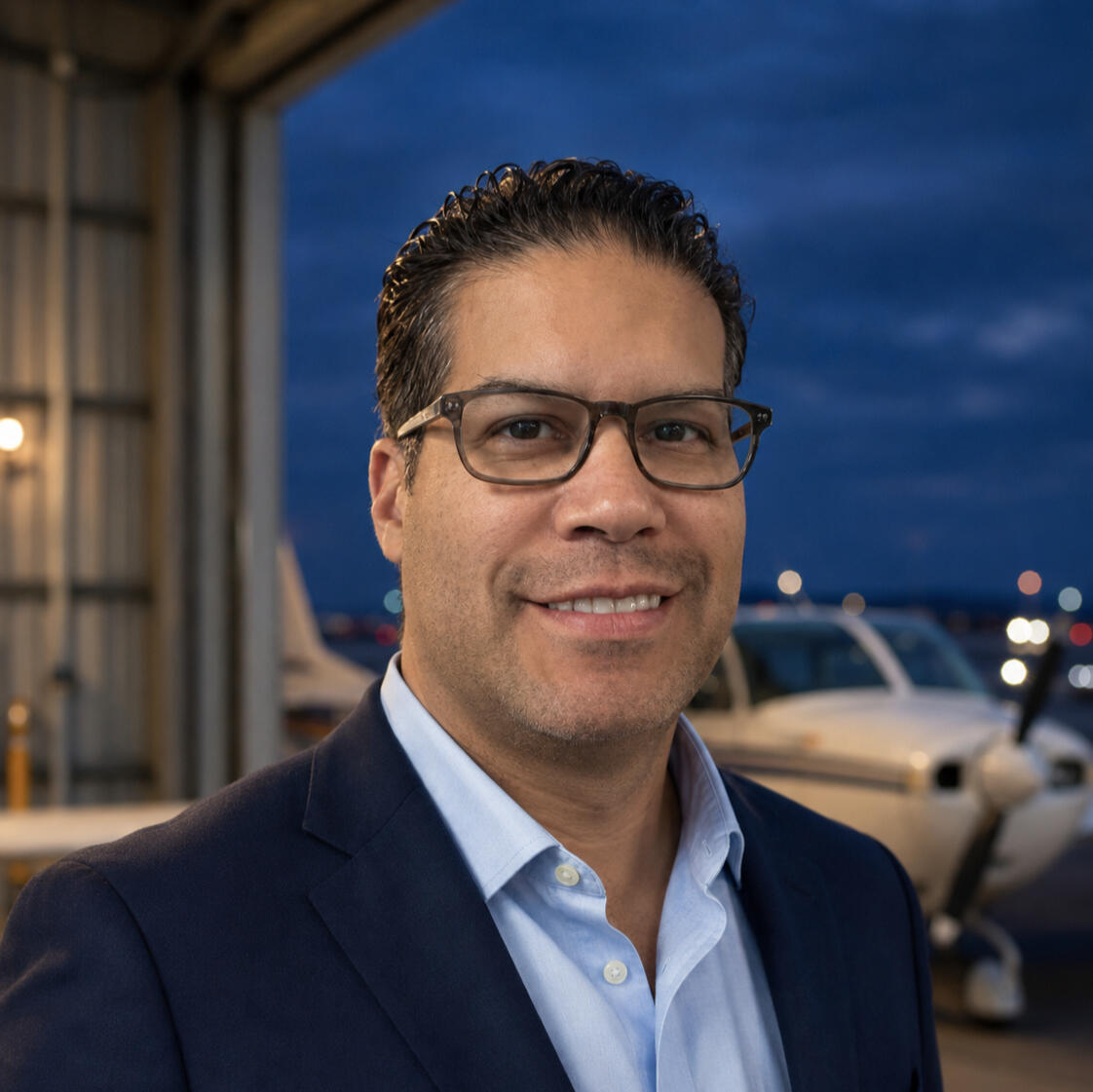 Andy Garcia Jr., aviation professional and entrepreneur, photographed beside a general aviation aircraft.